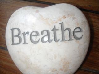 Heart shaped marble stone with the word Breathe on it