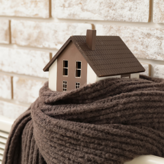 Model of a house with a scarf around it