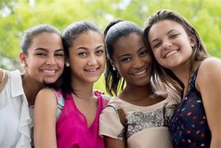 four teen girls smiling